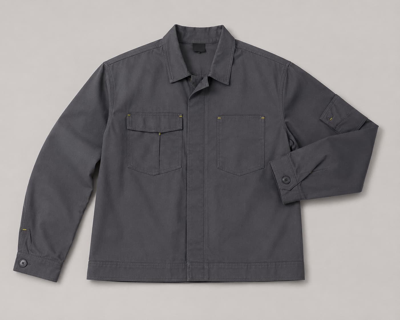 Grey utility work jacket with chest pockets and reinforced workwear stitching